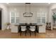 Dining room features a modern table with seating, shiplap walls, and window shutters at 6242 Creola Rd, Charlotte, NC 28270