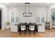 Dining area with shiplap walls, modern light fixture, and white upholstered chairs at 6242 Creola Rd, Charlotte, NC 28270