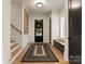 Inviting entryway with hardwood floors, a stylish rug, and convenient bench seating at 6242 Creola Rd, Charlotte, NC 28270