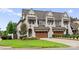 Elegant home exterior with a brick facade, arched entryway, and three-car garage at 6242 Creola Rd, Charlotte, NC 28270
