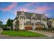 Stunning two-story home with a three-car garage, lush lawn, and meticulously maintained landscaping at 6242 Creola Rd, Charlotte, NC 28270