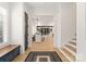 Bright foyer with hardwood floors, staircase, and entryway into dining and living areas at 6242 Creola Rd, Charlotte, NC 28270