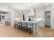 Gourmet kitchen with white cabinets, marble countertops, and modern stainless-steel appliances at 6242 Creola Rd, Charlotte, NC 28270