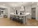 Stylish kitchen featuring white cabinetry, marble countertops, and stainless steel appliances with barstool seating at 6242 Creola Rd, Charlotte, NC 28270
