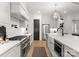 Bright kitchen with a large island, modern appliances, white cabinets, and tile backsplash at 6242 Creola Rd, Charlotte, NC 28270