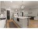 Bright kitchen with a large island, farm sink, stainless steel appliances, and hardwood floors at 6242 Creola Rd, Charlotte, NC 28270