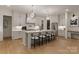 Spacious kitchen features an island with seating, stainless steel appliances and stylish pendant lighting at 6242 Creola Rd, Charlotte, NC 28270