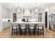 Well-lit kitchen featuring a center island with seating, modern lighting, and ample cabinet space at 6242 Creola Rd, Charlotte, NC 28270