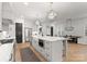 Bright kitchen with a large island, stainless steel appliances, white cabinets, and pendant lighting at 6242 Creola Rd, Charlotte, NC 28270