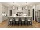 Well-appointed kitchen featuring stainless steel appliances, a large island with barstool seating, and modern lighting at 6242 Creola Rd, Charlotte, NC 28270