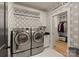 Well-organized laundry room with modern washer and dryer and stylish wallpaper at 6242 Creola Rd, Charlotte, NC 28270