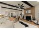 Open living space featuring a fireplace, wood beams, and seamless transition to the dining area and modern kitchen at 6242 Creola Rd, Charlotte, NC 28270