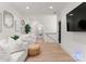 A brightly lit living room features hardwood floors, plush white sofas, and curated decor at 6242 Creola Rd, Charlotte, NC 28270