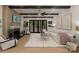 Bright and airy living room featuring a fireplace, modern furnishings, and large doors that lead to the backyard at 6242 Creola Rd, Charlotte, NC 28270