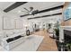 Open-concept living room with beamed ceiling, fireplace, and seamless flow into the kitchen and dining area at 6242 Creola Rd, Charlotte, NC 28270