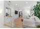 Bright and airy living room featuring neutral tones, hardwood floors, and a glimpse into the laundry room at 6242 Creola Rd, Charlotte, NC 28270