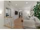 Cozy living room area with hardwood floors, neutral decor, and doorway to laundry at 6242 Creola Rd, Charlotte, NC 28270