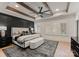 Spacious main bedroom with hardwood floors, tray ceiling, and accent wall at 6242 Creola Rd, Charlotte, NC 28270