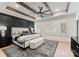 Spacious main bedroom boasting exposed beams, a decorative ceiling fan, and a luxurious upholstered bed at 6242 Creola Rd, Charlotte, NC 28270