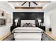 Elegant main bedroom with a decorative accent wall, stylish lamps, and a plush bed, creating a serene retreat at 6242 Creola Rd, Charlotte, NC 28270
