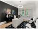 Home office with black accent wall, bright window with shutters, unique light fixture, and stylish decor at 6242 Creola Rd, Charlotte, NC 28270