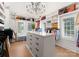 This walk-in closet boasts custom shelving, center island with drawers, and ample natural light from the windows at 6242 Creola Rd, Charlotte, NC 28270