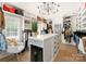 Spacious walk-in closet boasts custom shelving, center island with beverage cooler, and natural light from window at 6242 Creola Rd, Charlotte, NC 28270