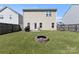 The backyard features a fire pit, a lawn, and a grill ready for outdoor fun and entertainment at 6945 Agava Ln, Charlotte, NC 28215