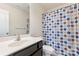 Bathroom showcasing a single sink vanity and a colorful shower curtain at 6945 Agava Ln, Charlotte, NC 28215