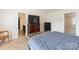 This bedroom has plush carpet, a dresser, a TV, and ensuite bathroom access at 6945 Agava Ln, Charlotte, NC 28215