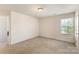 An additional bedroom showcasing neutral carpet and natural light from the window at 6945 Agava Ln, Charlotte, NC 28215