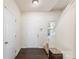 Inviting entryway featuring dark hardwood floors, neutral walls, and staircase at 6945 Agava Ln, Charlotte, NC 28215
