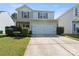 Traditional-style home showcasing a two-car garage and neatly landscaped front yard at 6945 Agava Ln, Charlotte, NC 28215