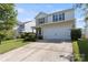 Two-story home with an attached two-car garage, lawn, and manicured bushes at 6945 Agava Ln, Charlotte, NC 28215