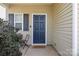 Inviting entryway featuring a stylish blue front door and neutral siding at 6945 Agava Ln, Charlotte, NC 28215