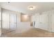 Hallway featuring neutral walls, carpeted floors, and multiple doors at 6945 Agava Ln, Charlotte, NC 28215