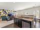 View of kitchen and living room with modern accent wall and stainless steel appliances at 6945 Agava Ln, Charlotte, NC 28215