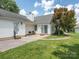 Patio with outdoor seating and a grill, accessible via sliding glass doors, sits adjacent to a grassy yard at 703 Bradberry Ln, Indian Trail, NC 28079