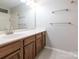 Bathroom vanity with a bright mirror and gray tile flooring at 703 Bradberry Ln, Indian Trail, NC 28079