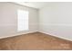 Cozy bedroom with carpet flooring, neutral walls, and bright natural light at 703 Bradberry Ln, Indian Trail, NC 28079