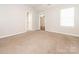 Neutral bedroom with carpet flooring, white walls, and a doorway at 703 Bradberry Ln, Indian Trail, NC 28079