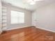 Bedroom with hardwood flooring, built-in shelving, and a window at 703 Bradberry Ln, Indian Trail, NC 28079