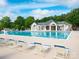 Community pool with clear water and plenty of lounge chairs for residents to enjoy at 703 Bradberry Ln, Indian Trail, NC 28079