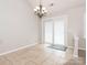 Bright dining area with tile flooring, a chandelier, and sliding door access to the exterior at 703 Bradberry Ln, Indian Trail, NC 28079