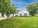 Charming single story home with blue shutters and a well-manicured lawn at 703 Bradberry Ln, Indian Trail, NC 28079