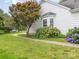 Exterior view of a well-maintained home with manicured landscaping, flowering bushes, and a walkway at 703 Bradberry Ln, Indian Trail, NC 28079