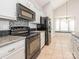 Well-equipped kitchen with sleek appliances, granite counters, and white cabinetry at 703 Bradberry Ln, Indian Trail, NC 28079