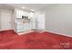 Kitchenette with white cabinets, and red carpet flooring at 703 Bradberry Ln, Indian Trail, NC 28079