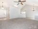 Open-concept living space featuring neutral paint, carpeted floors, and modern lighting at 703 Bradberry Ln, Indian Trail, NC 28079