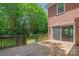 Wooden deck and a brick exterior overlook a landscaped backyard, providing an inviting outdoor space at 7301 Leharne Dr, Charlotte, NC 28270